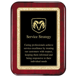 Rosewood plaque, customized engraved lettering and a design on top of them.